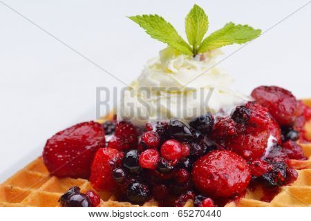 a selection of three italian gelato ice-cream scoops topped with nuts, chocolate, fruit served on crispy waffels