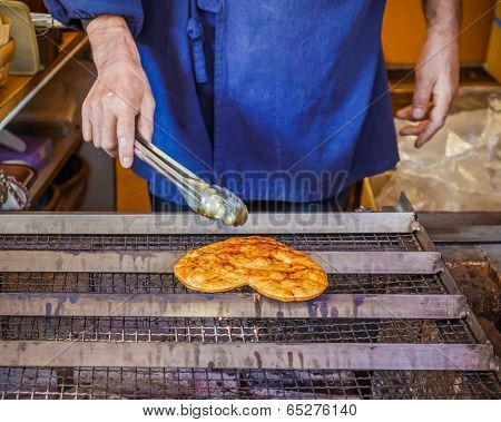 Grilled  Senbei (Japanese Rice Crisp Pancake) on a stove