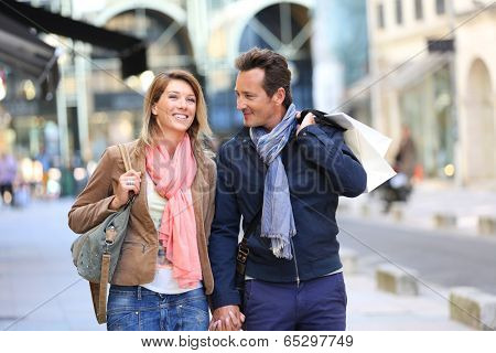 Middle-aged couple doing shopping on week-end
