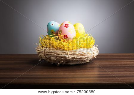 Easter Nest With Decoration Eggs On Table, Gray Background