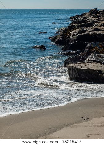 Gentle Beach Waves With A Rock Jetty