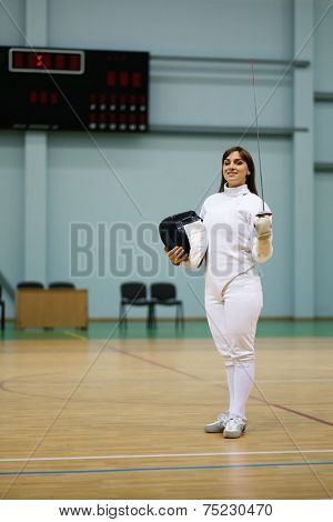 Young woman fencer with epee 