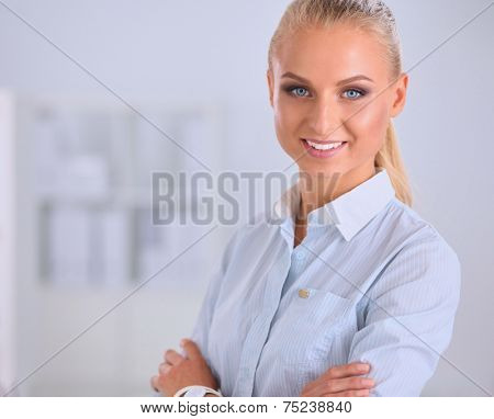 Attractive businesswoman with her arms crossed stnding