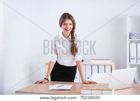Attractive businesswoman with her arms crossed stnding