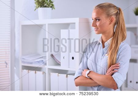 Attractive businesswoman with her arms crossed stnding