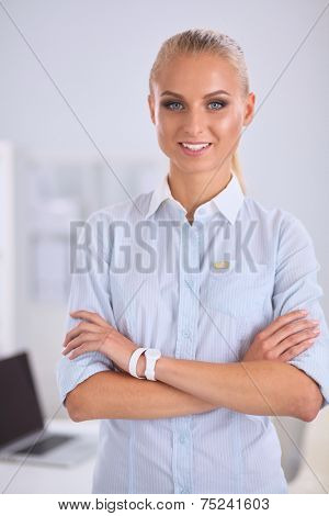 Attractive businesswoman with her arms crossed stnding