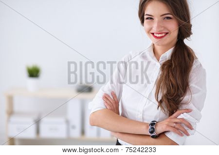 Attractive businesswoman with her arms crossed stnding