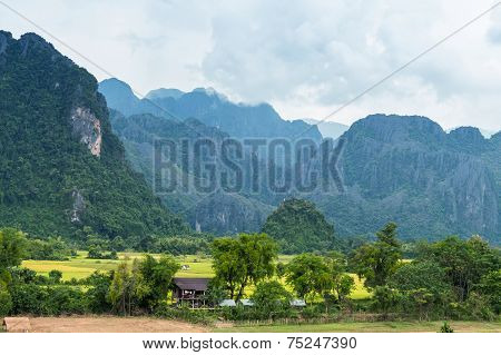 VANG VIENG LAO P.D.R. - October 24 : Unidentified tourists are rowing kayak boats in Song River on O