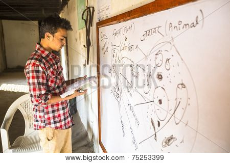 KATHMANDU, NEPAL - DEC 9, 2013: Unknown teacher in lesson at Jagadguru School. School established at 2013, to let new generation learn Sanskrit and preserve Hindu culture.