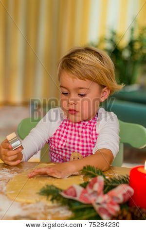 child baking cookies for christmas. cookies for the christmas season