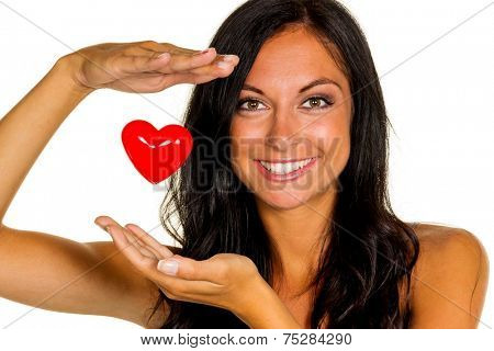 a loving young woman holds a heart in his hand