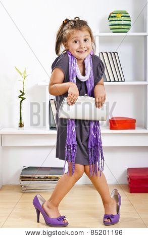 little girl in mother clothes
