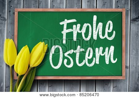 Yellow tulips against frohe ostern