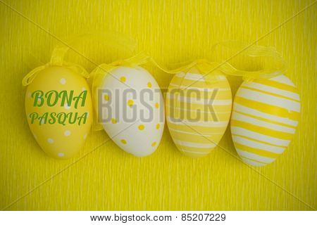 bona pascua against four easter eggs in a row