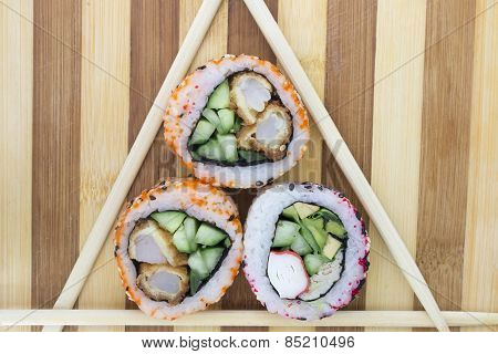 Rolls With Chopsticks On A Cutting Board