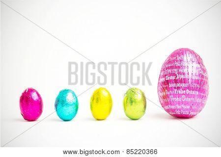 Happy easter in different languages against four small easter eggs beside large one