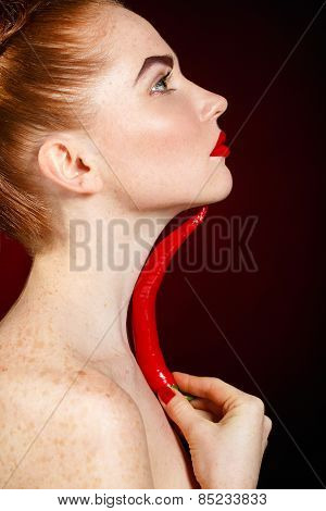 Sexy brunette girl with red cayennes isolated on black