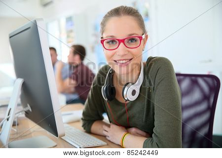 Smiling student with pink eyeglasses
