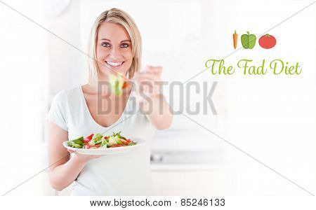 The word the fad diet against close up of a good looking woman eating salad