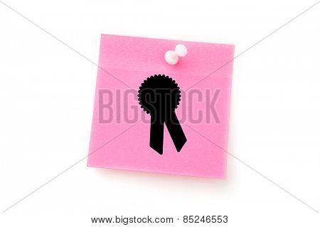 Merit badge against pink adhesive note with pushpin