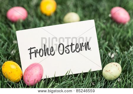 frohe ostern against blank greeting card with easter eggs