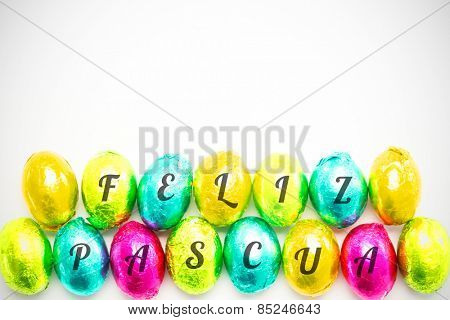 feliz pasqua against colourful foil wrapped easter eggs