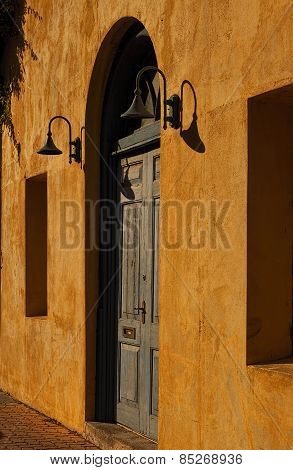 Weathered Blue Door In A Yellow Wall