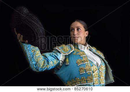 Woman Bullfighter Salutes With His Montera In Black Background