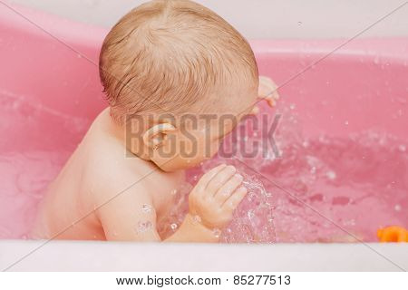 child bathes in a bathtub