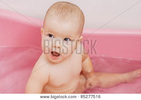 child bathes in a bathroom