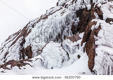 Ice Stalactites On Volcanic Rocks