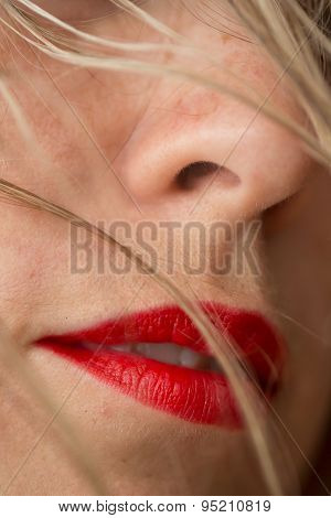 Beautiful woman's red lips and blonde hair