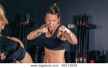 Woman training hard boxing in the gym