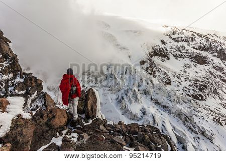 Climber Walking Through Snow, Ice And Rocks.