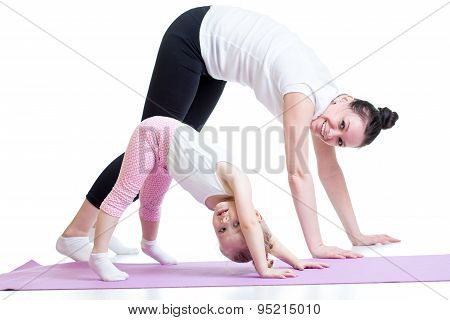Mother and her child doing gimnastics