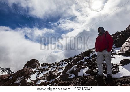 Climber Walking Through Snow, Ice And Rocks.