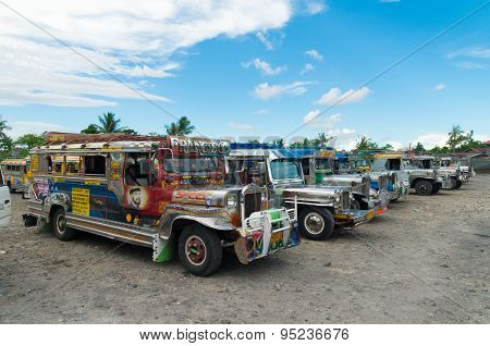 NAGA CITY, PHILIPPINES - JUNE 3, 2015: Colorful jeepneys at a jeepney terminal. Jeepneys are the most popular means of public transportation in the Philippines.