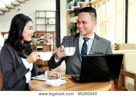 Two Business People Look Happy While Having A Coffee Break