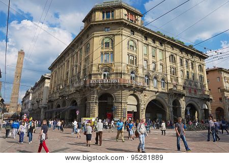 People walk by the Francesco Rizzoli street in Bologna, Italy.