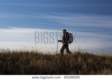 Female hiker walks along the ridge