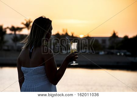 Amazing Sunset girl drink glass cocktail in Sultanate Oman at Souly Bay harbour and Hotels Oceanside