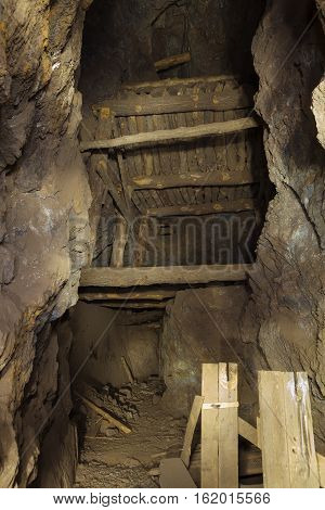 Inside an abandoned gold mine in the Nevada desert showing timbers and support structure.