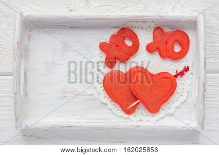 Red velvet pancakes with xo sign (hugs and kisses) and heart on wooden tray horizontal top view copy space