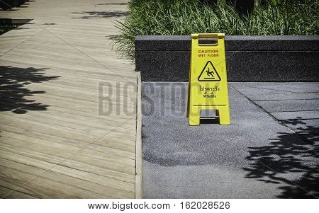 Wet floor sign in the garden, oudoor.