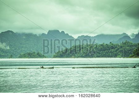 Mountain view with sky cloud fog and water surface at chiewlarn dam or ratchaprapa dam Suratthani Thailand.