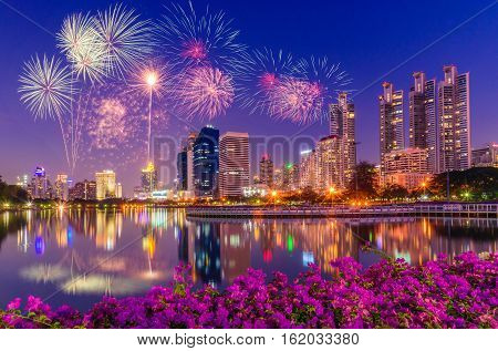 Firework over Benchakitti Park at twilight time in Bangkok Thailand.