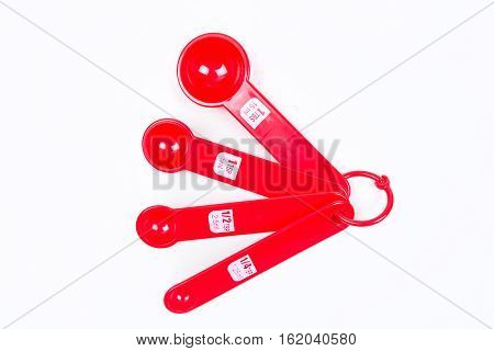 Red Measuring Spoons Isolated On White Background