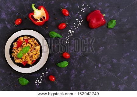 Radiatori Pasta With Chicken And Peppers On Dark Background. Top View