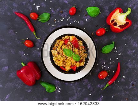 Radiatori Pasta With Chicken And Peppers On Dark Background. Top View
