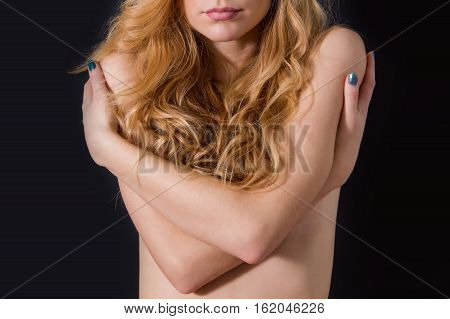 Sensual topless beautiful blond haired girl isolated on black background, no face, anonymous